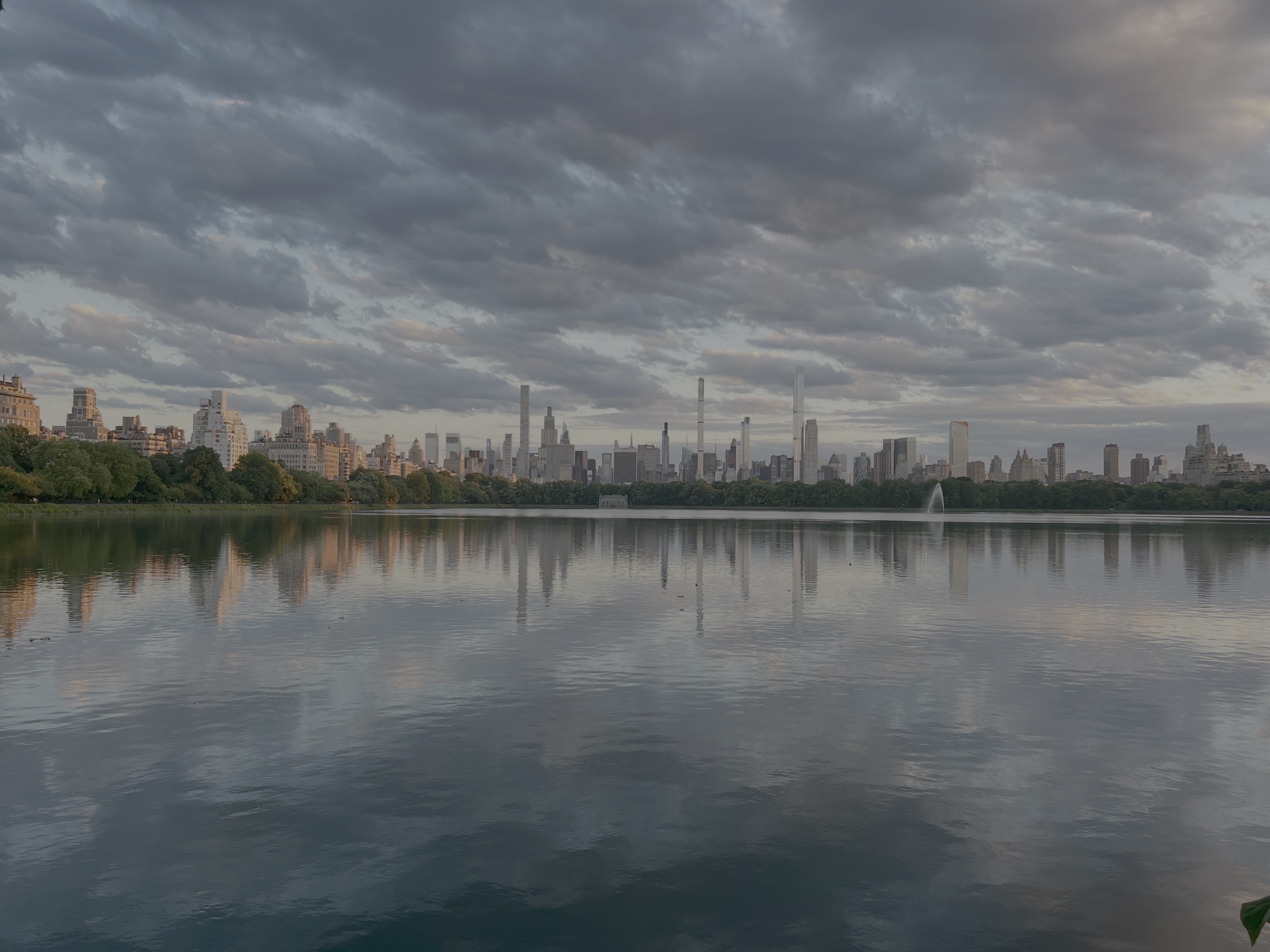 A low deck of stratocumulus over the Central Park Reservoir, with the Manhattan skyline reflected in the water